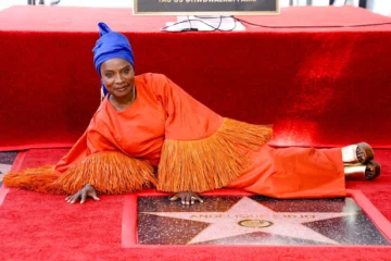 Angélique Kidjo, cinq fois lauréate d'un Grammy, est devenue, mardi, la première Africaine noire à se voir décerner une étoile sur le Walk of Fame d'Hollywood. Lors d'une cérémonie fastueuse organisée sous les palmiers et sous un ciel californien digne d'une carte postale, Kidjo a été mise à l'honneur par des stars de cinéma et des grands noms de l'industrie musicale alors qu'elle dévoilait son étoile sur cette artère très fréquentée. « Nous, les Africains, nous ne savons pas tout ce que nous avons apporté au monde », a déclaré cette femme de 66 ans. « Sans nous, la musique serait impossible sur cette planète. » Après avoir remercié son équipe et sa famille, Kidjo s'est mise à chanter tandis que les personnes présentes l'écoutaient avec une attention captivée. Née au Bénin, Kidjo mène une carrière internationale depuis plus de 40 ans et compte 18 albums à son actif. En plus d'avoir été désignée comme l'une des 100 personnalités les plus influentes par le magazine Time, elle a également été désignée comme l'une des 50 figures les plus emblématiques d'Afrique par la BBC et comme l'une des 100 personnalités les plus inspirantes au monde par The Guardian. Harvey Mason Jr., de la Recording Academy, a salué Kidjo en la qualifiant d'« artiste exceptionnelle ». « Votre exemple a enrichi notre communauté musicale mondiale et votre travail ne cesse de nous rappeler que la musique est bien plus qu'un simple divertissement : c'est un lien », a-t-il déclaré. « Cette étoile est un symbole éternel ; elle ne disparaîtra jamais et elle symbolise vos réalisations. Mais votre héritage, lui, perdure à travers les personnes que vous avez touchées, que vous avez inspirées, les barrières que vous avez brisées, les liens que vous avez tissés aux quatre coins du monde. » L'acteur Willem Dafoe a salué l'immense énergie dont fait preuve Kidjo sur scène. « La première fois que j'ai vu Angélique se produire sur scène, j'ai trouvé que sa musique, sa danse et son engagement étaient incroyables », a déclaré la star de « Platoon ». « C'est, sans aucun doute, la femme la plus travailleuse du monde du spectacle. » Mais, a-t-il ajouté, ce qui était encore plus impressionnant, c'était son engagement en faveur de l'action humanitaire de sa fondation Batonga, qui œuvre pour l'autonomisation des filles et des jeunes femmes en Afrique. « Il ne s'agit pas d'un engagement symbolique de la part d'une célébrité ; c'est le prolongement de ce qu'elle fait à travers sa musique. Elle nous touche, nous inspire et nous rappelle que nous sommes tous liés, et que l'amour et la compréhension sont la voie à suivre. »